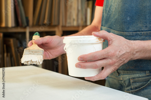 An artist priming canvas photo