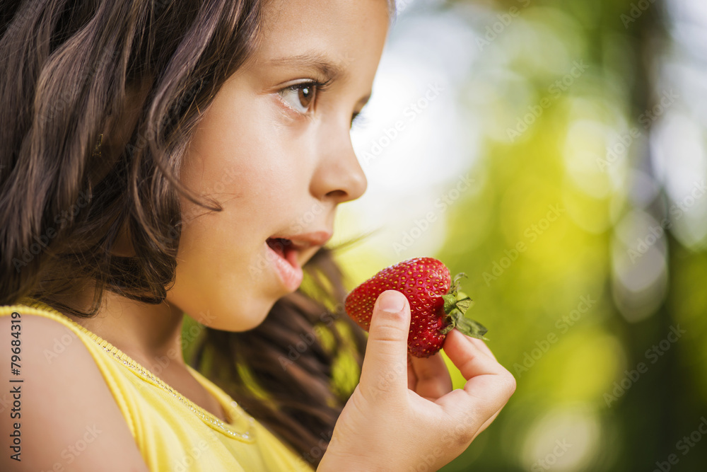 Little girl with strawberries. Selective focus Little girl with strawberries. Selective focus