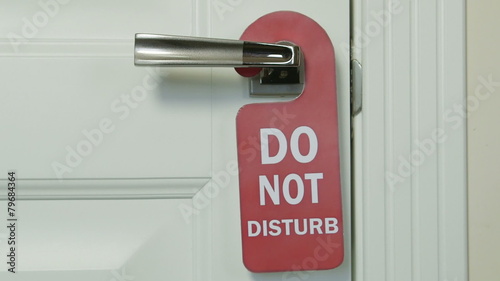 Do not disturb sign on hotel room door photo