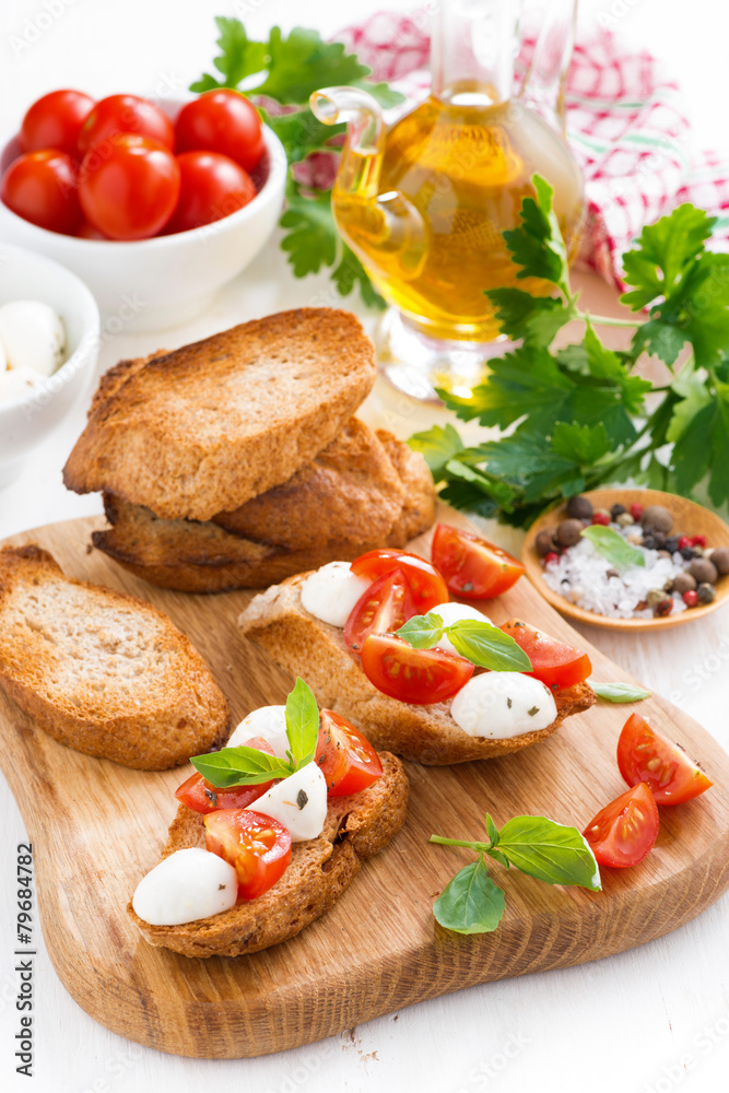 toasts with mozzarella, basil and cherry tomatoes