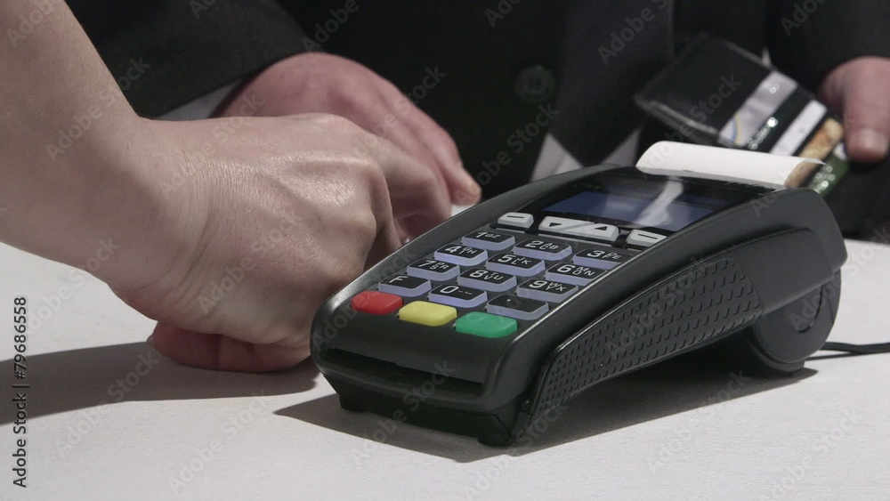 Person using credit card processing terminal in Ukraine Person using credit card processing terminal in Ukraine