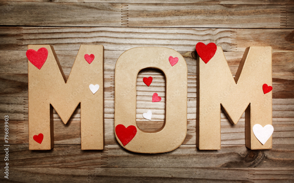 MOM text in big cardboard letters with heart shaped decorations