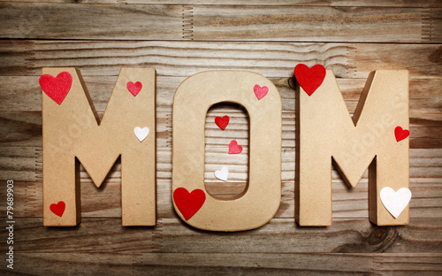 MOM text in big cardboard letters with heart shaped decorations photo