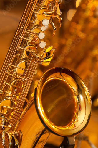 Fragment of the saxophone in golden tones