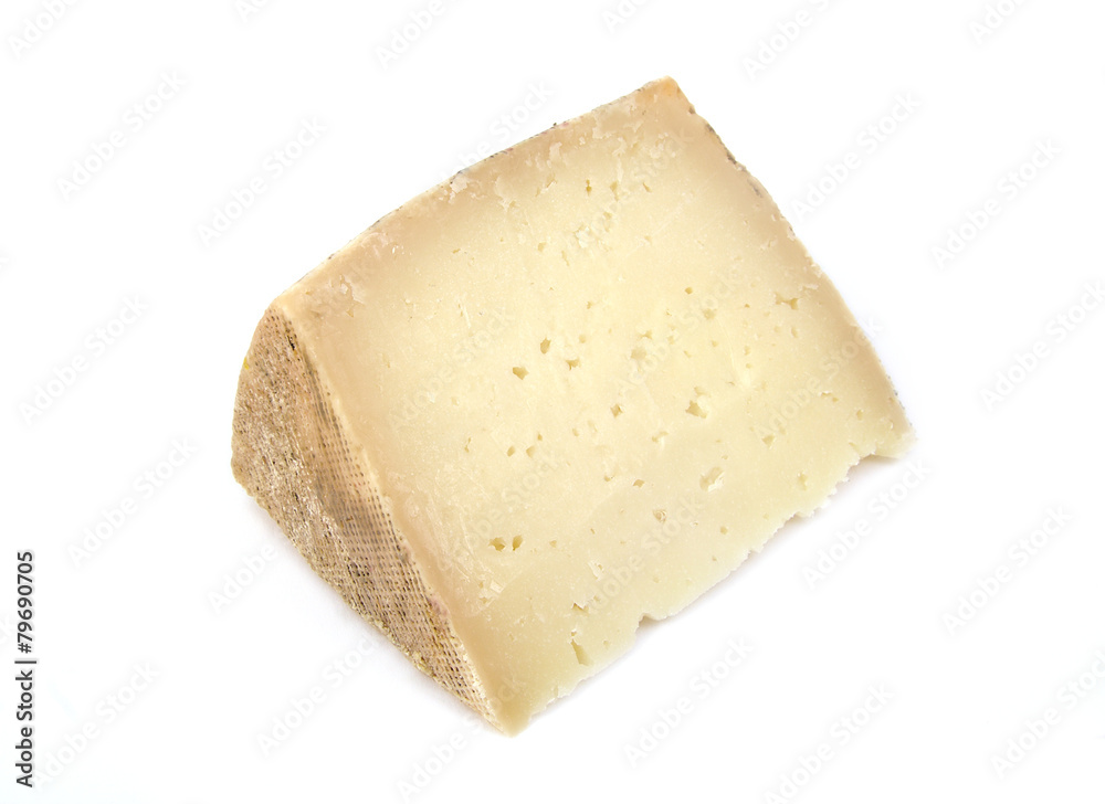 Delicious wedge of spanish machego cheese on a white background