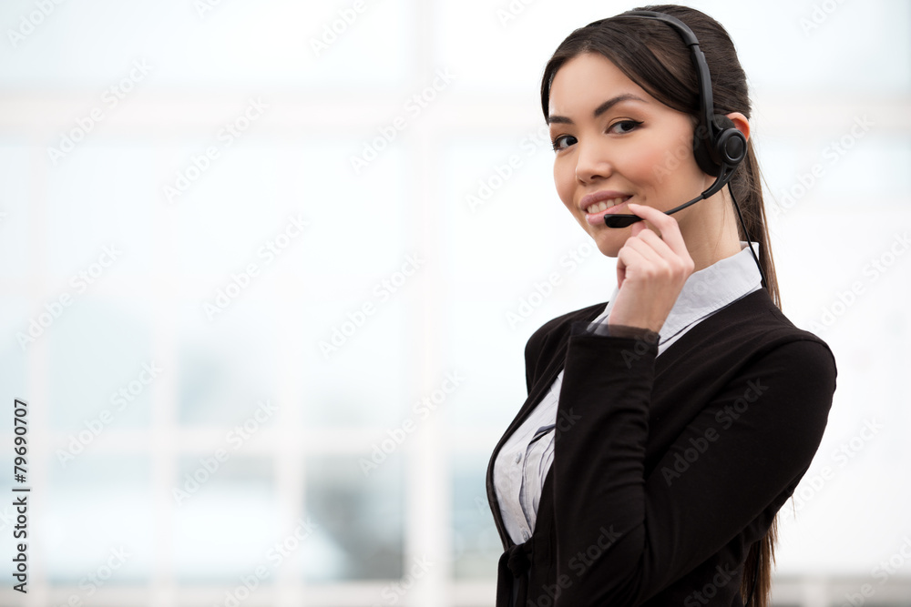 Asian call center female operator looking at camera Asian call center female operator looking at camera