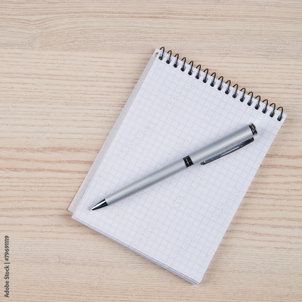 Blank notepad with pen on office wooden table Blank notepad with pen on office wooden table