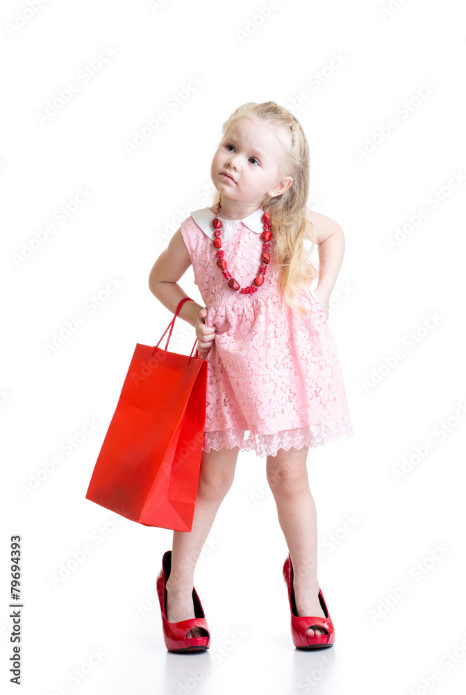 Funny little girl trying on mother's accessories and shoes Funny little girl trying on mother's accessories and shoes