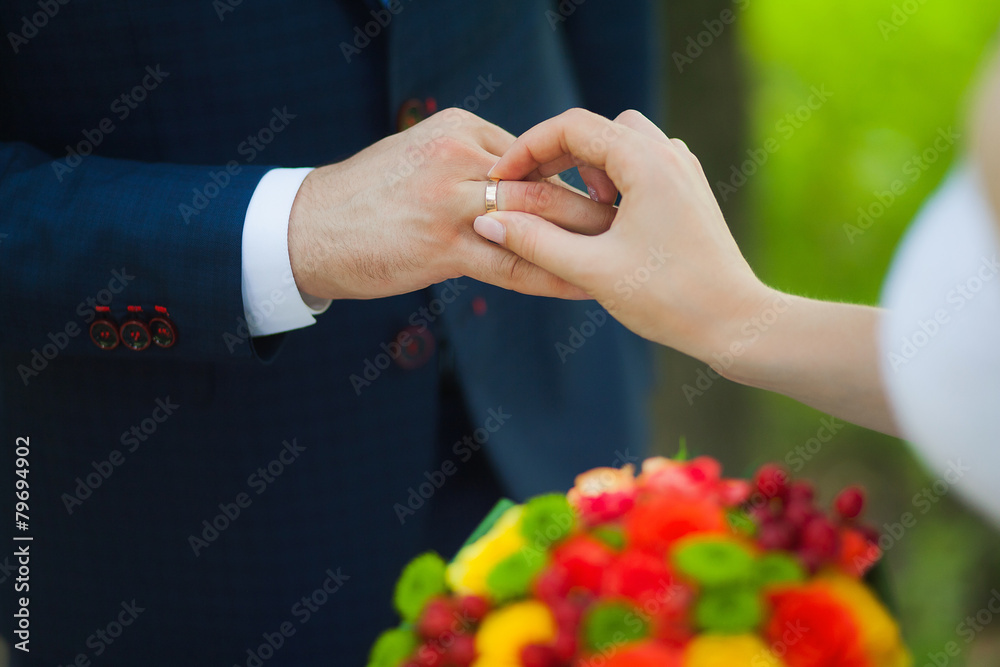 closeup of hands of bridal couple with wedding rings