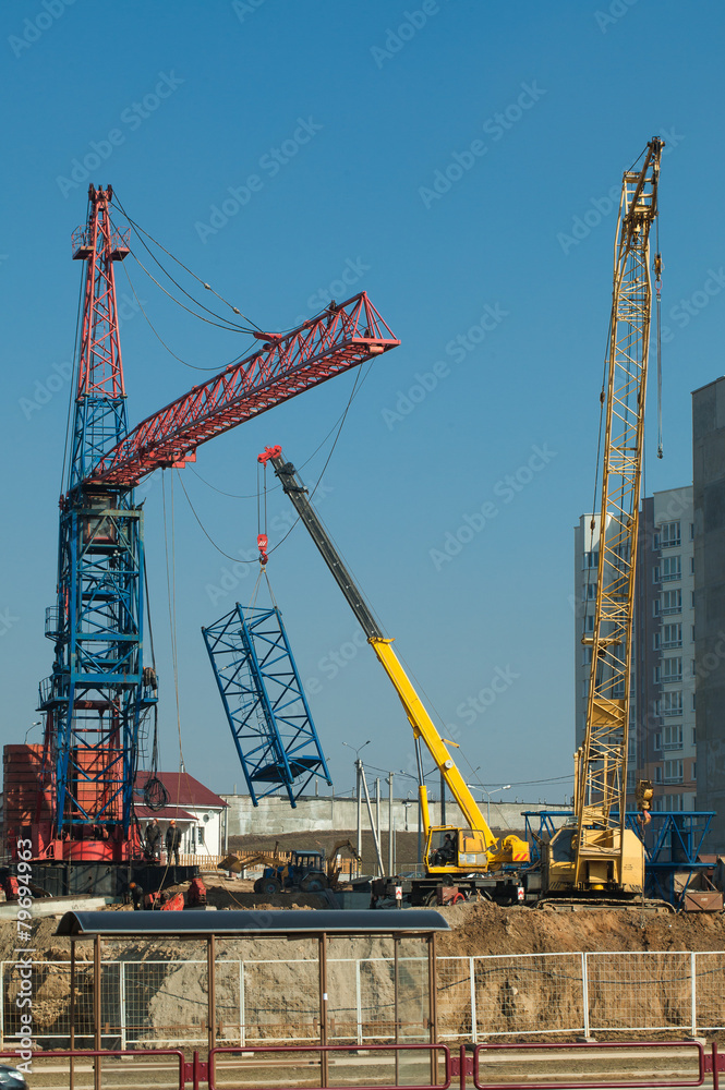Fitting and Installation a construction crane at a building site