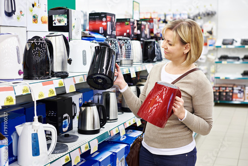 Woman housewife shopping for electric kettle
