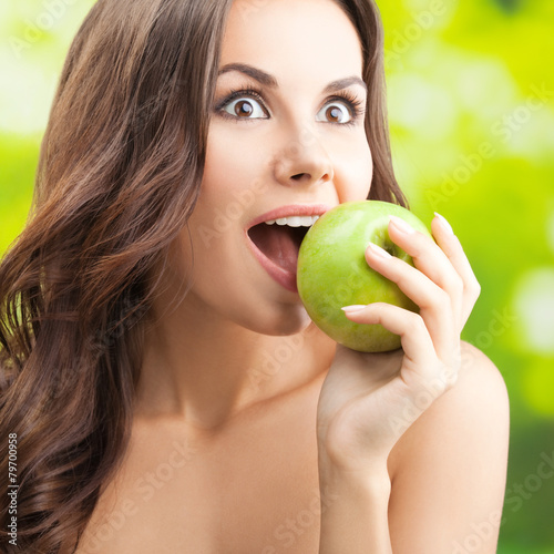 Woman eating apple, outdoor