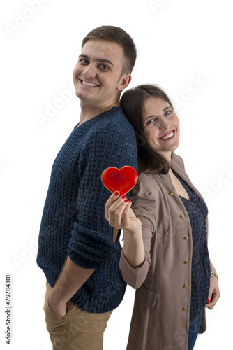 Young couple smiling and having a read heart isolated