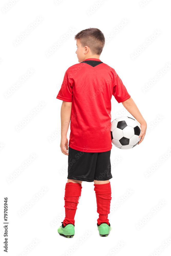 Rear view shot of a junior soccer player holding a ball