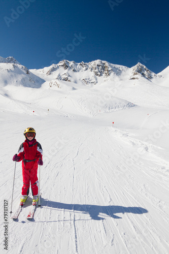Happy girl skier on a ski slope