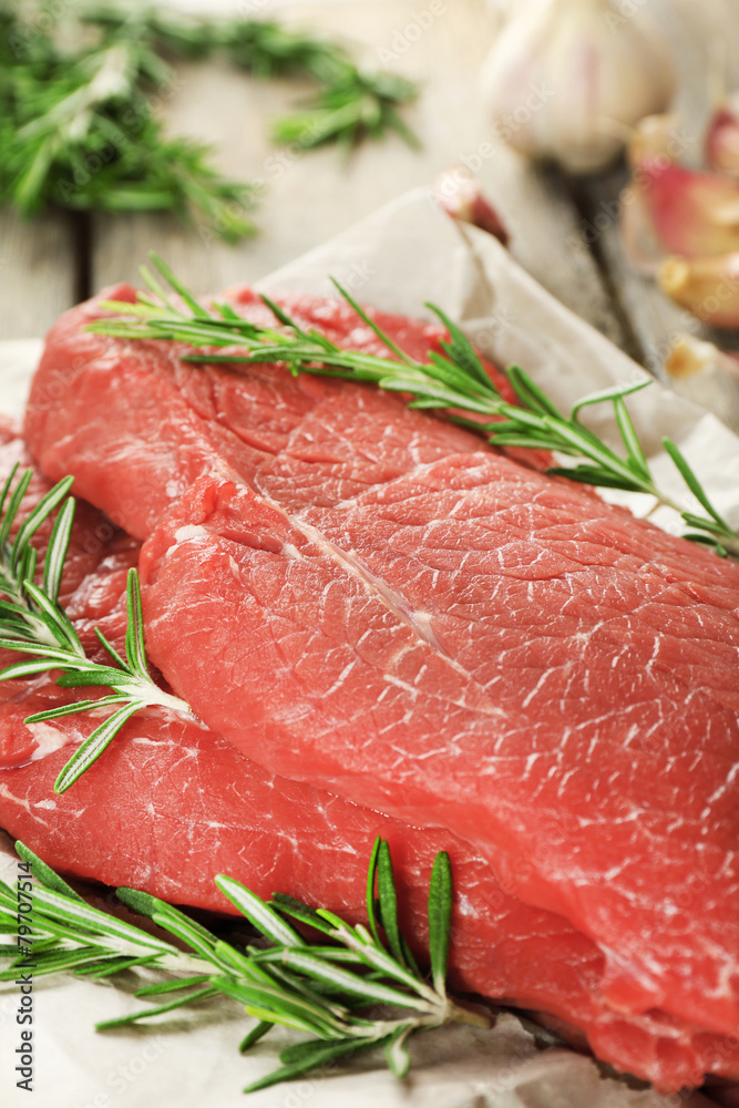 Raw beef steak with rosemary and garlic