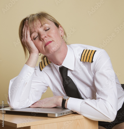 Tired female airline pilot wearing insignia of a captain photo