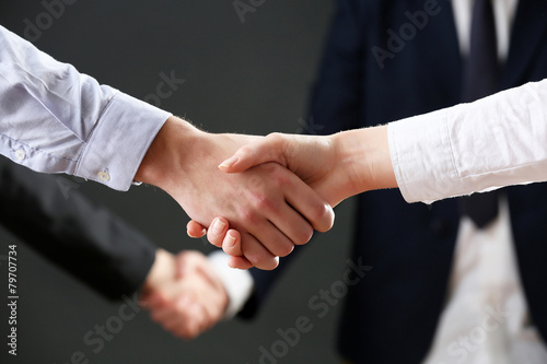 Business handshake on dark background