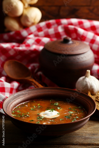 Ukrainian beetroot soup - borscht in bowl and pot,