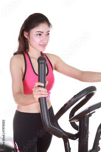 young woman doing exercises with exercise machine