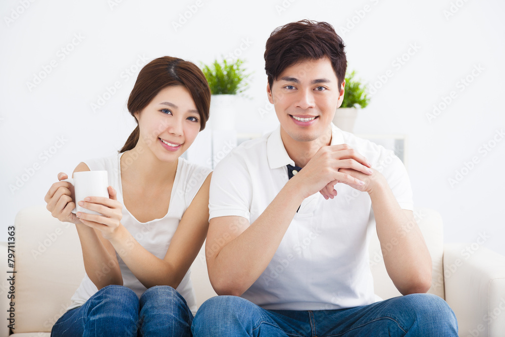 happy Young couple relaxing in sofa happy Young couple relaxing in sofa