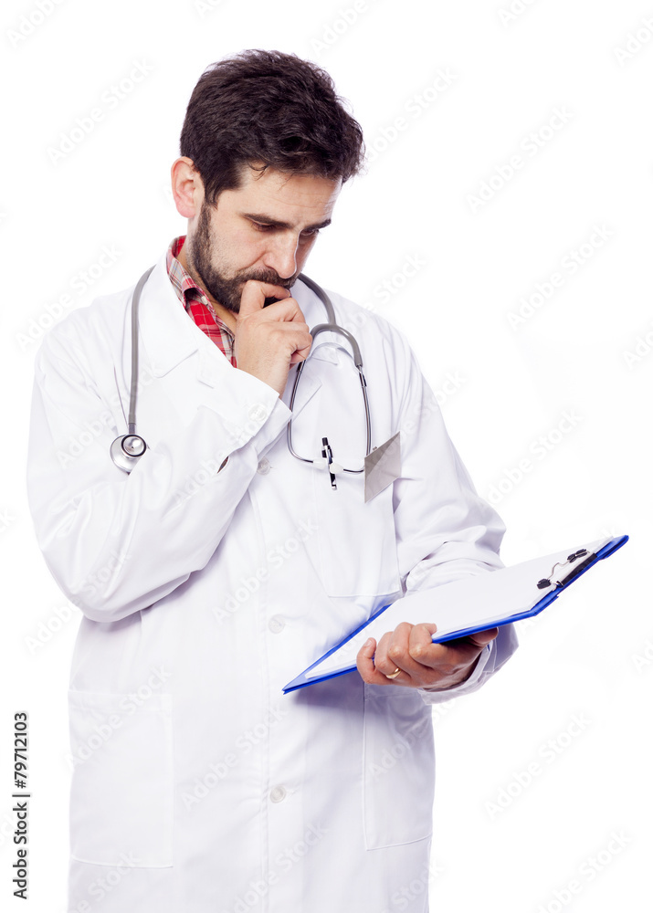 Pensive young doctor looking to the clipboard, isolated on white Pensive young doctor looking to the clipboard, isolated on white