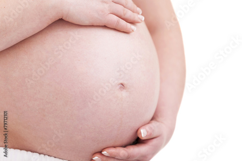 Close up of a pregnant belly, isolated on white background