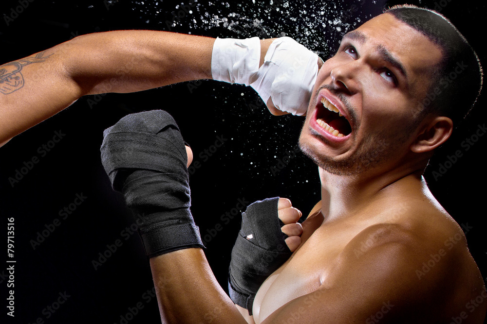 mma fighter or boxer losing and getting hit in the face Photos | Adobe Stock