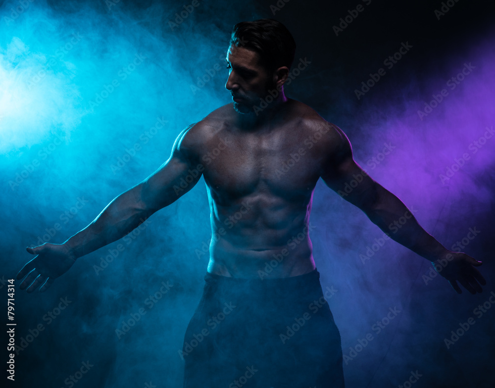 Obraz premium Silhouette Shirtless Muscled Man Posing in Smoke
