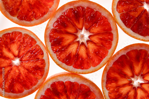 Red orange cut in round juicy slices, blood background colour