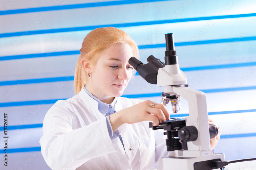 technician in the laboratory using a microscope technician in the laboratory using a microscope
