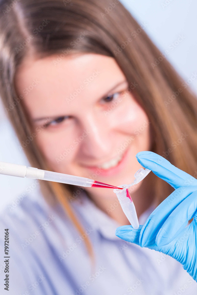 technician in the laboratory with a pipette and test tube technician in the laboratory with a pipette and test tube