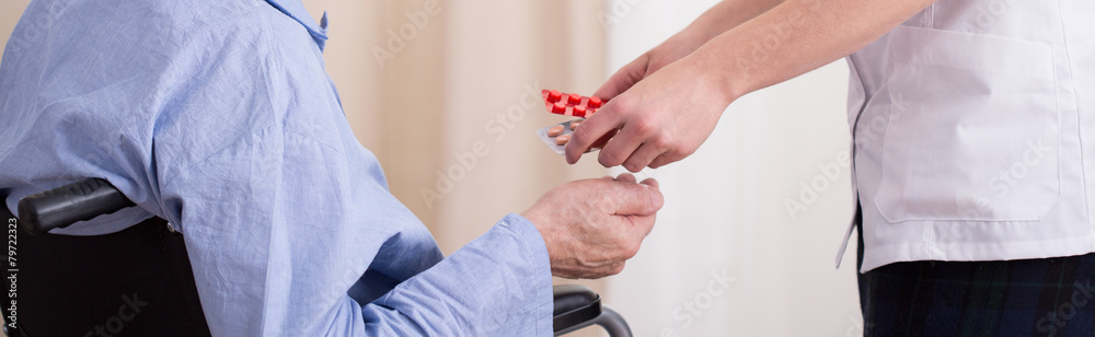 Nurse giving patient medicament