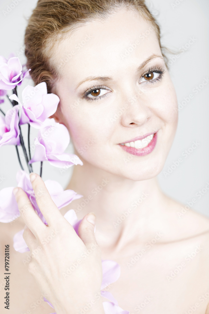 Fototapeta premium Woman holding up Orchids