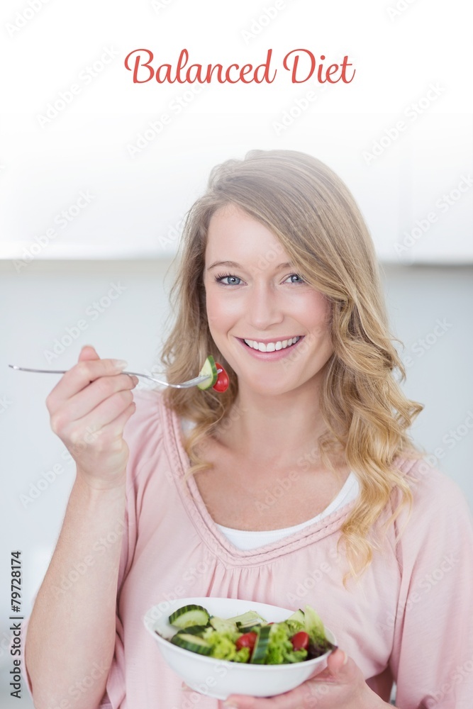 Balanced diet against woman having salad in kitchen