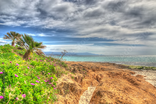 orange rocks in Le Bombarde beach in hdr