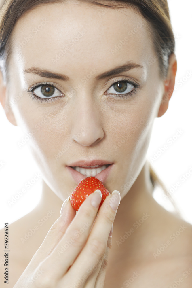 Woman enjoying a fresh strawberry Woman enjoying a fresh strawberry