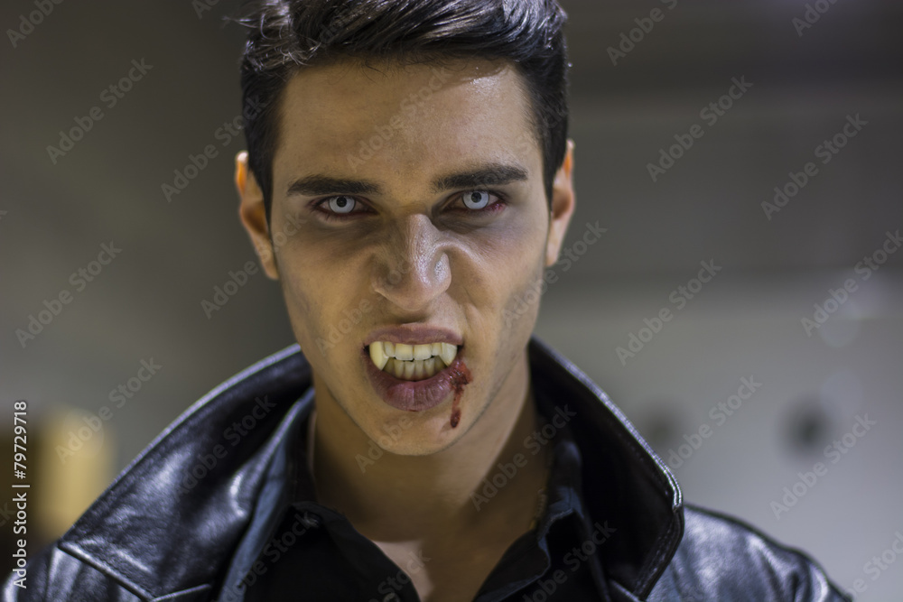 Naklejka premium Young Vampire Man Face with Blood on his Mouth