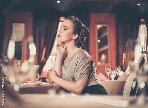 Beautiful young girl in luxury restaurant interior