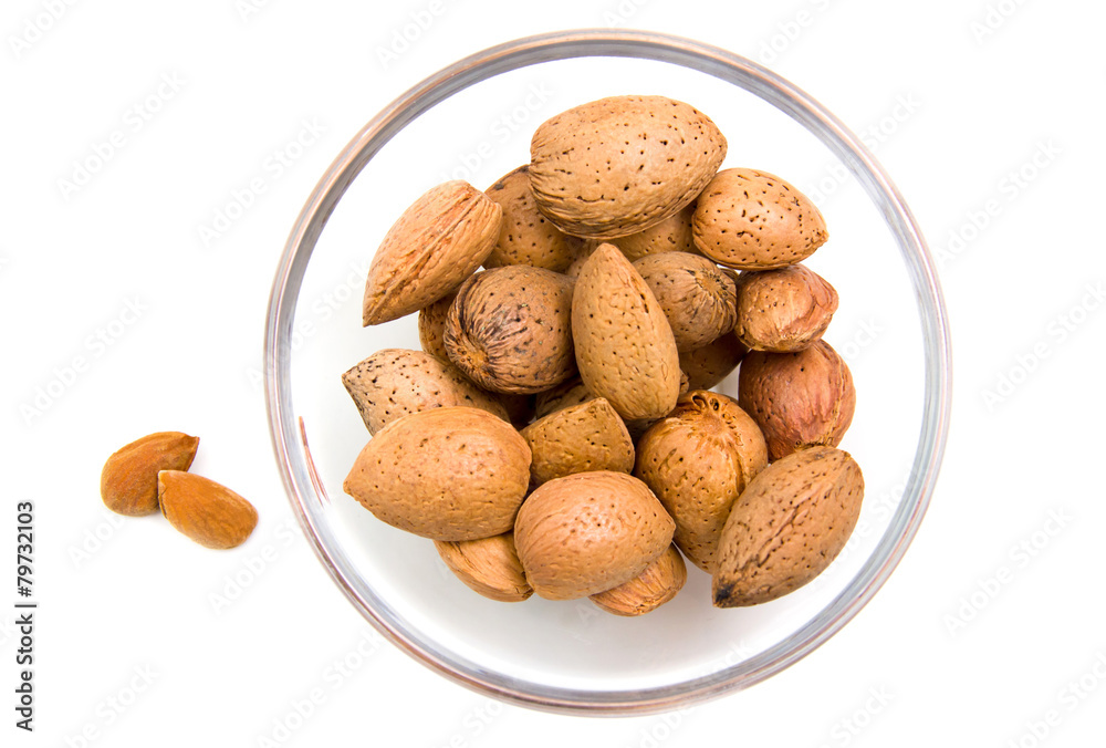 Almonds on bowl on white background viewed from above Almonds on bowl on white background viewed from above