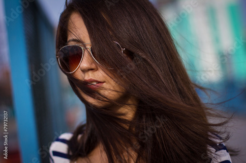 Portrait of stylish woman with glasses on the street