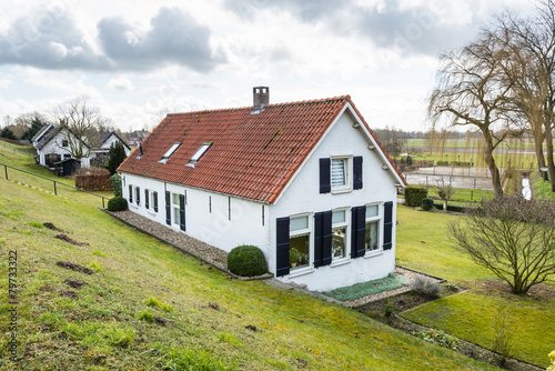 Old houses at the bottom of a Dutch dike