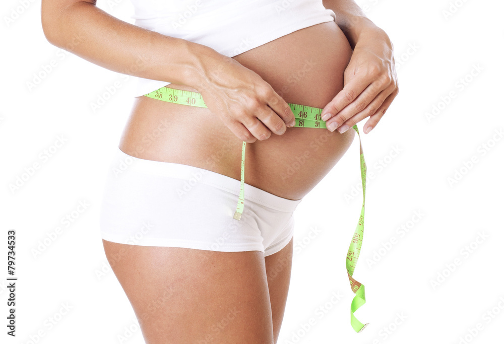 Pregnant woman measuring a waist