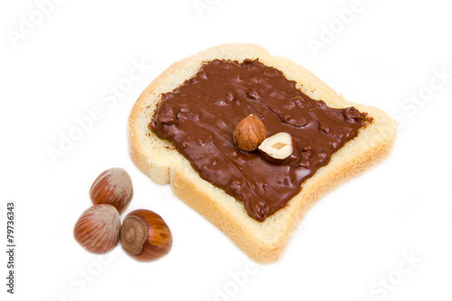 Slice of bread with chocolate hazelnut on white background
