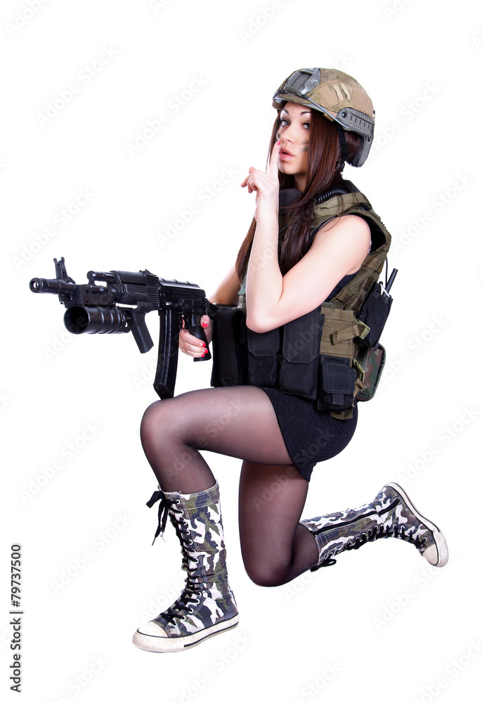 Woman in a military camouflage sitting with the assault rifle Woman in a military camouflage sitting with the assault rifle