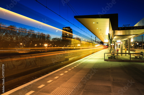 Train leaving a train station in Groningen in the evening.
