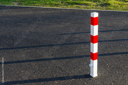 reflective traffic bollard guarding an entrance to a street photo