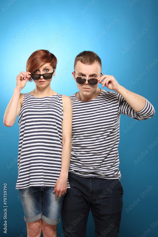 Couple in striped clothing, stripped vest, in sunglasses Couple in striped clothing, stripped vest, in sunglasses