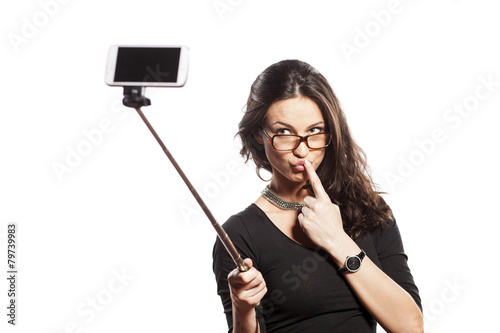 pretty brunette making selfie with a stick