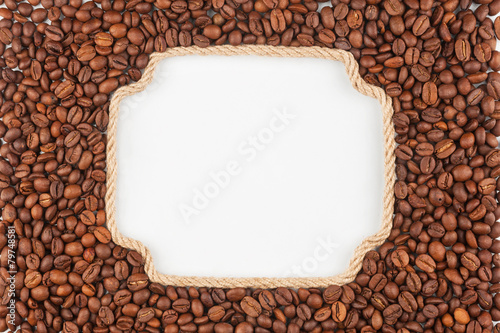 Figured frame made of rope with coffee beans lying on a white